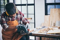 a man working with a circular saw in a workshop